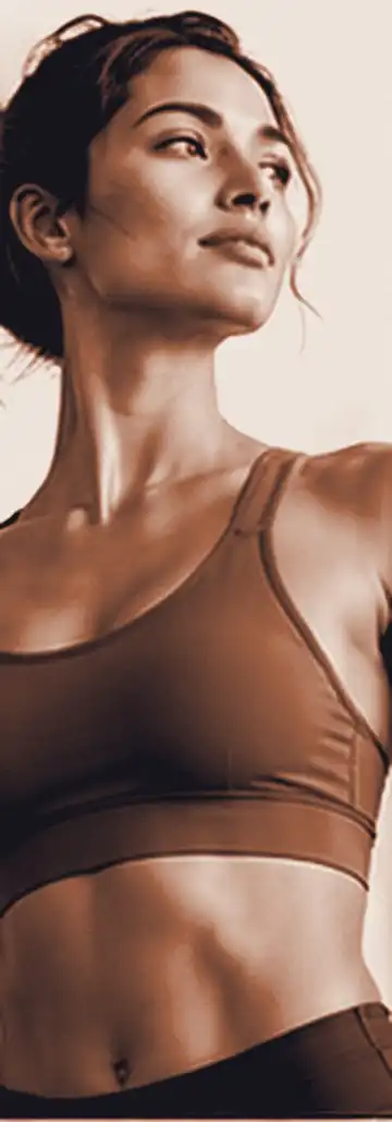 Woman in workout wear looking ahead with quiet confidence