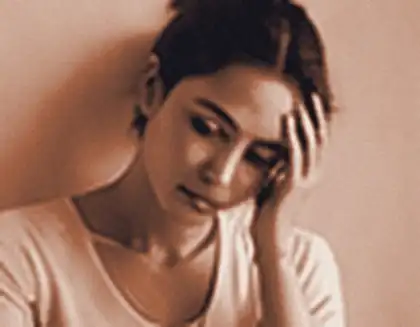 Tired woman holding her head